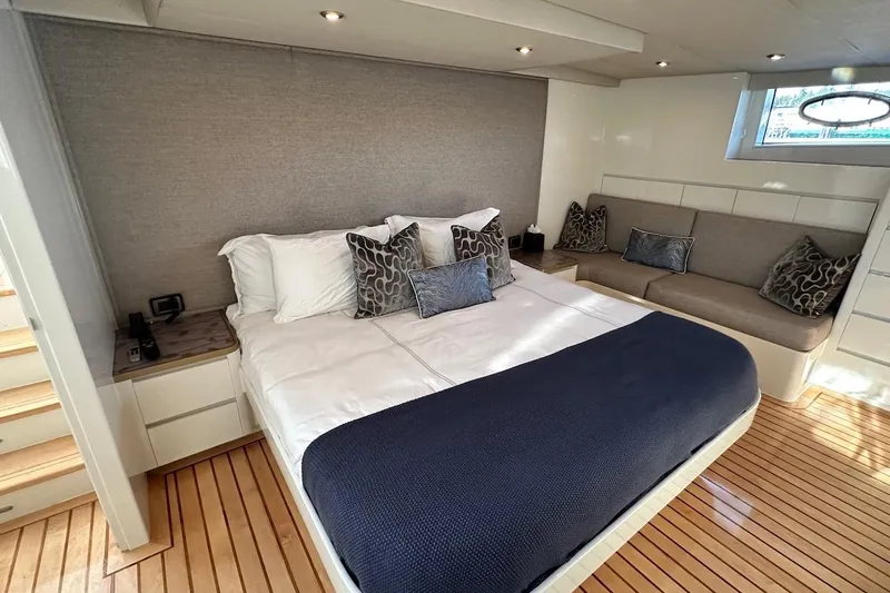 First Home Yacht Photos Pics Luxurious bedroom interior of 1988 Cheoy Lee 92 yacht with elegant decor and wooden flooring.