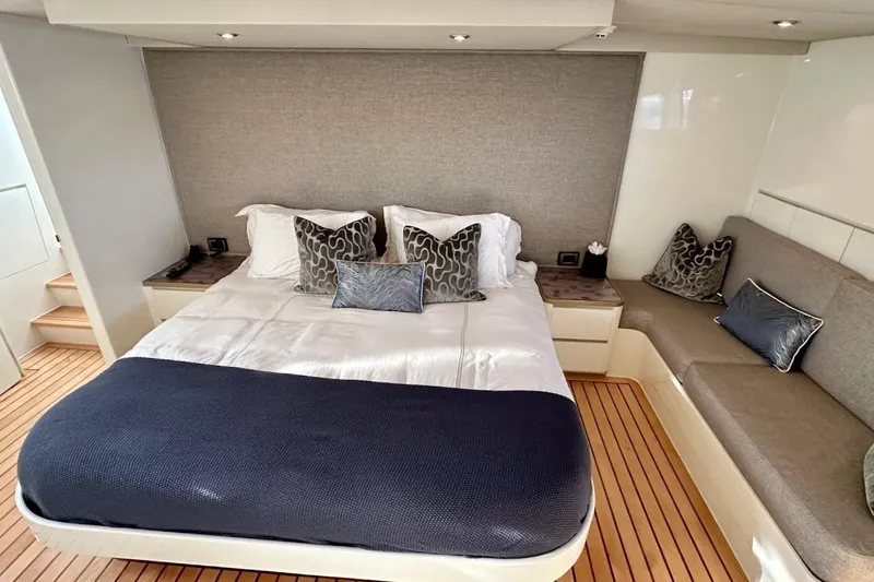 First Home Yacht Photos Pics Luxurious bedroom interior of 1988 Cheoy Lee 92 yacht with elegant bedding and seating.