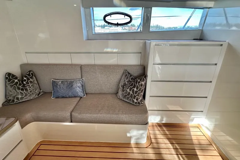 First Home Yacht Photos Pics Luxurious interior of 1988 Cheoy Lee 92 yacht with modern seating and elegant decor.