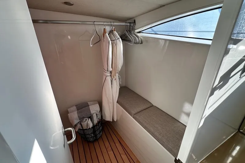 First Home Yacht Photos Pics Luxurious Cheoy Lee 92 yacht interior, featuring a cozy closet with robes and seating, 1988 model.