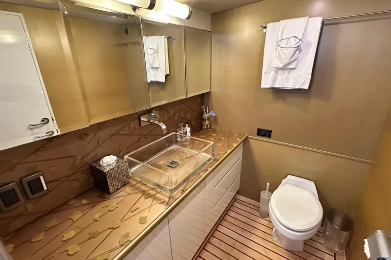 First Home Yacht Photos Pics Luxurious bathroom in 1988 Cheoy Lee 92 yacht with modern fixtures and elegant design.