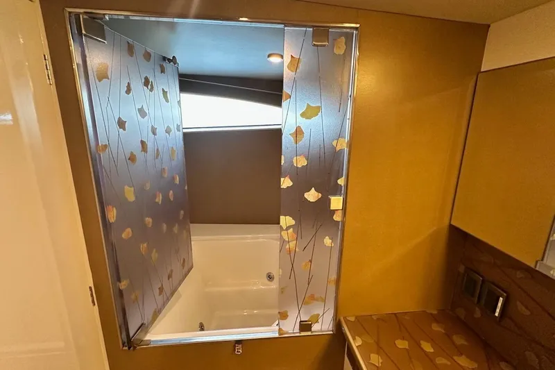 First Home Yacht Photos Pics Luxurious bathroom with leaf-patterned glass door on 1988 Cheoy Lee 92 yacht.