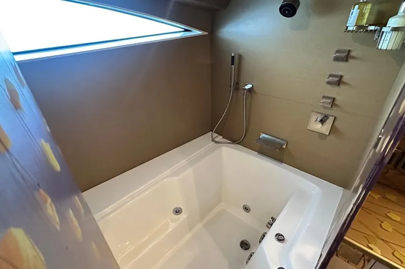 First Home Yacht Photos Pics Luxurious bathtub in 1988 Cheoy Lee 92 yacht, featuring modern fixtures and elegant design.