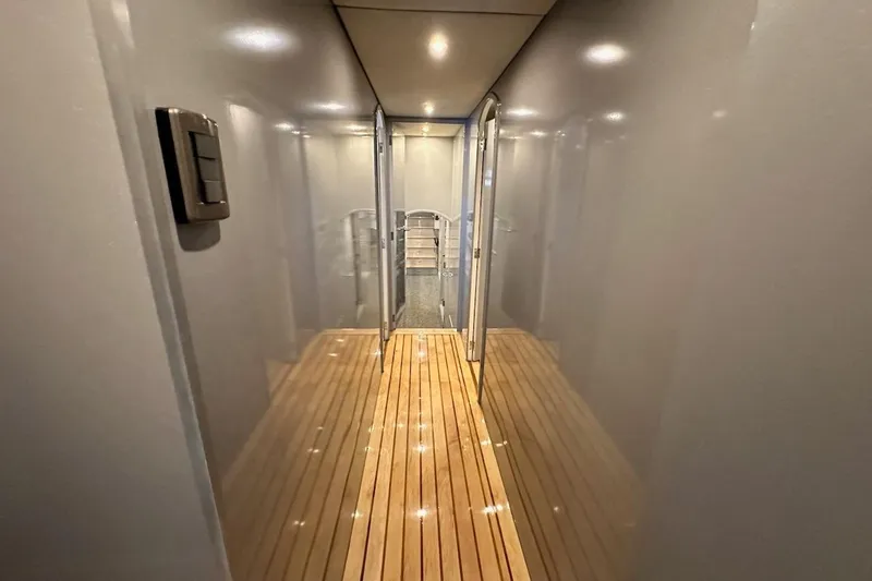 First Home Yacht Photos Pics Narrow hallway with wooden flooring inside a 1988 Cheoy Lee 92 yacht.