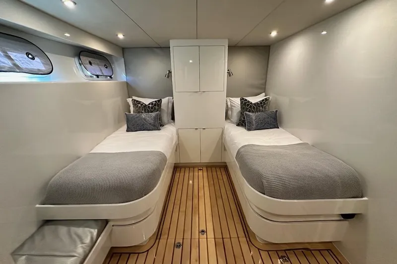 First Home Yacht Photos Pics Luxurious twin cabin on 1988 Cheoy Lee 92 yacht with modern decor and wood flooring.