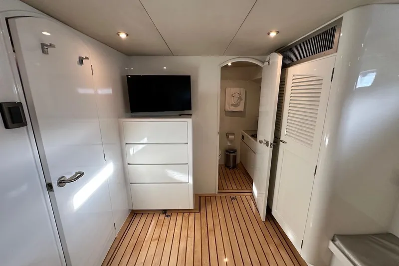 First Home Yacht Photos Pics Luxurious interior of 1988 Cheoy Lee 92 yacht with modern amenities and wooden flooring.