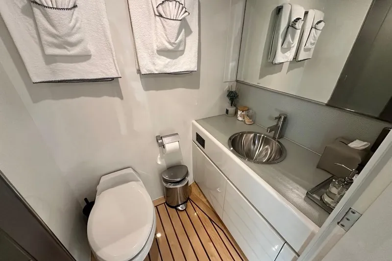 First Home Yacht Photos Pics Luxurious bathroom on 1988 Cheoy Lee 92 yacht with modern fixtures and elegant design.