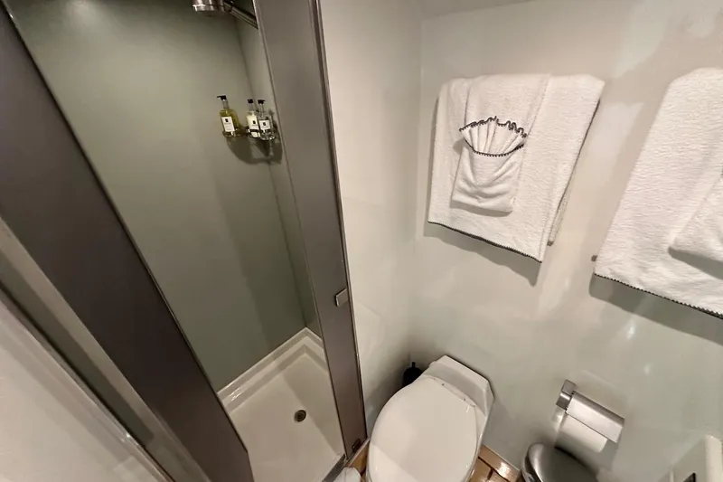 First Home Yacht Photos Pics Bathroom interior of 1988 Cheoy Lee 92 yacht with shower and towels.