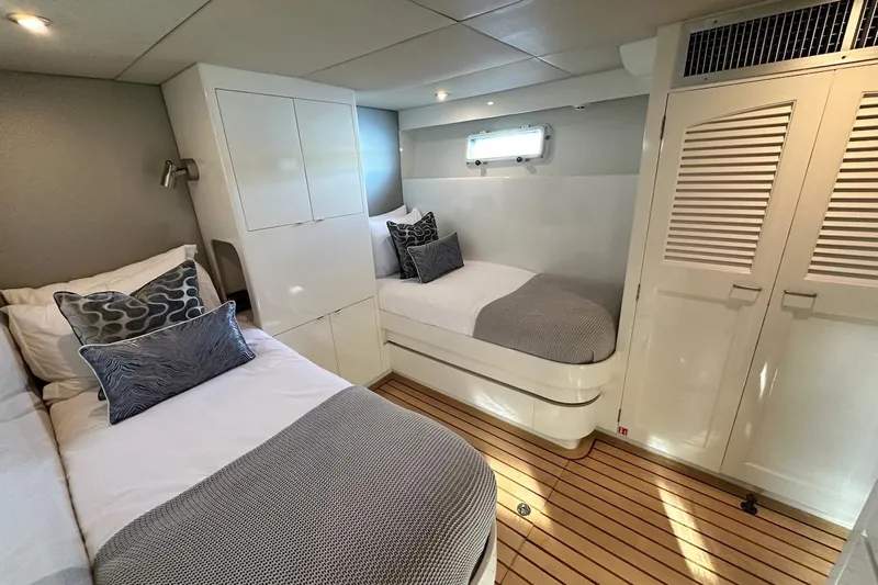 First Home Yacht Photos Pics Luxurious cabin interior of 1988 Cheoy Lee 92 yacht with twin beds and elegant decor.