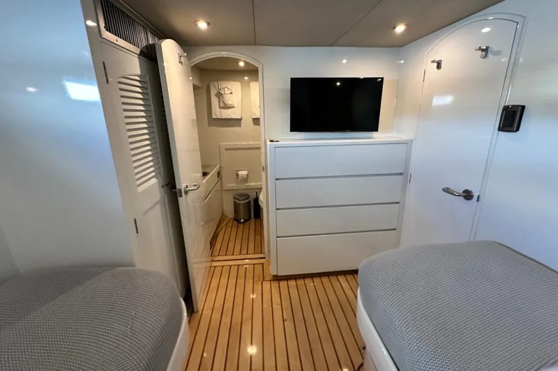 First Home Yacht Photos Pics Luxurious 1988 Cheoy Lee 92 yacht cabin with modern amenities and elegant wood flooring.