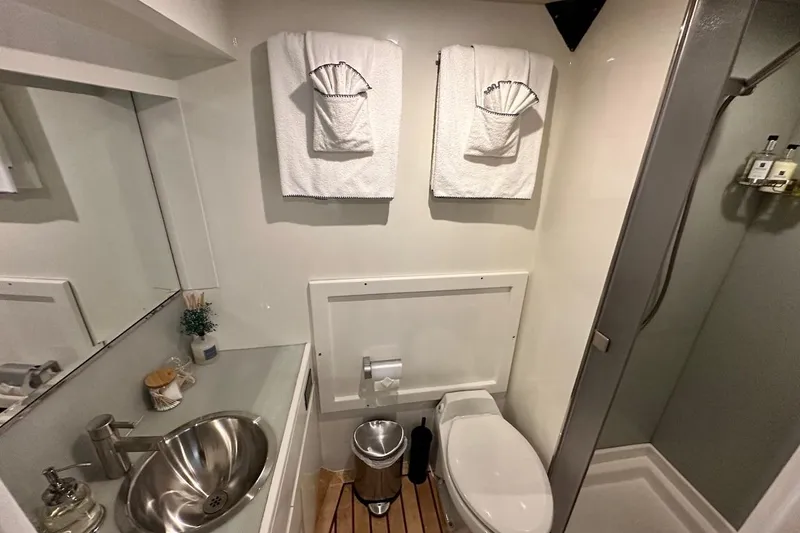First Home Yacht Photos Pics Luxurious bathroom in 1988 Cheoy Lee 92 yacht with modern fixtures and elegant decor.