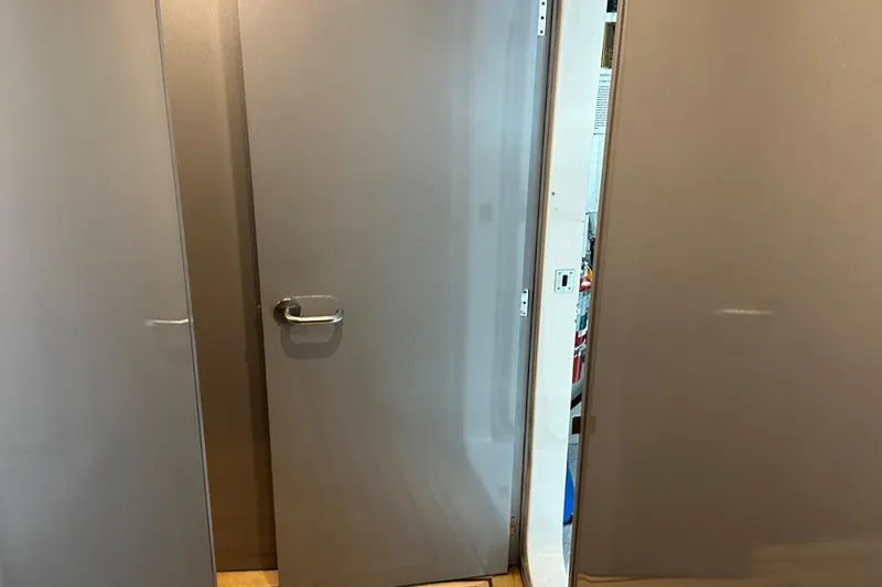 First Home Yacht Photos Pics Interior door of 1988 Cheoy Lee 92 yacht, partially open, with modern handle.