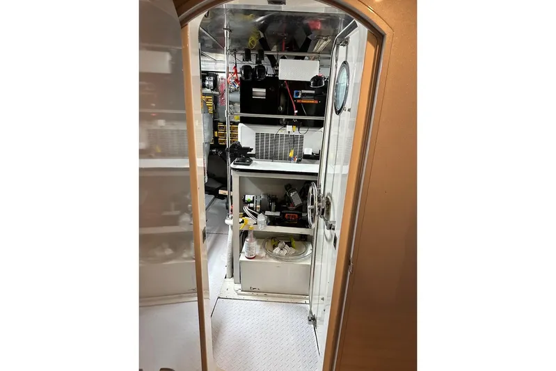 First Home Yacht Photos Pics Interior view of 1988 Cheoy Lee 92 yacht, showcasing organized storage and equipment.