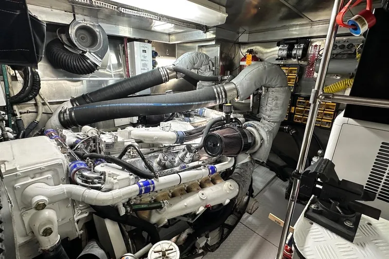 First Home Yacht Photos Pics Engine room of 1988 Cheoy Lee 92 yacht, showcasing complex machinery and piping.