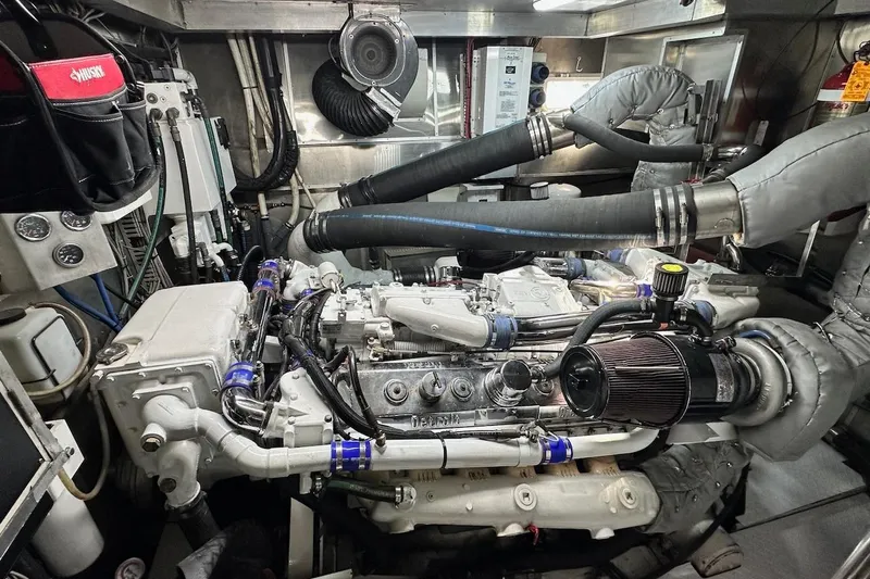 First Home Yacht Photos Pics Engine room of a 1988 Cheoy Lee 92 yacht, showcasing complex machinery and components.