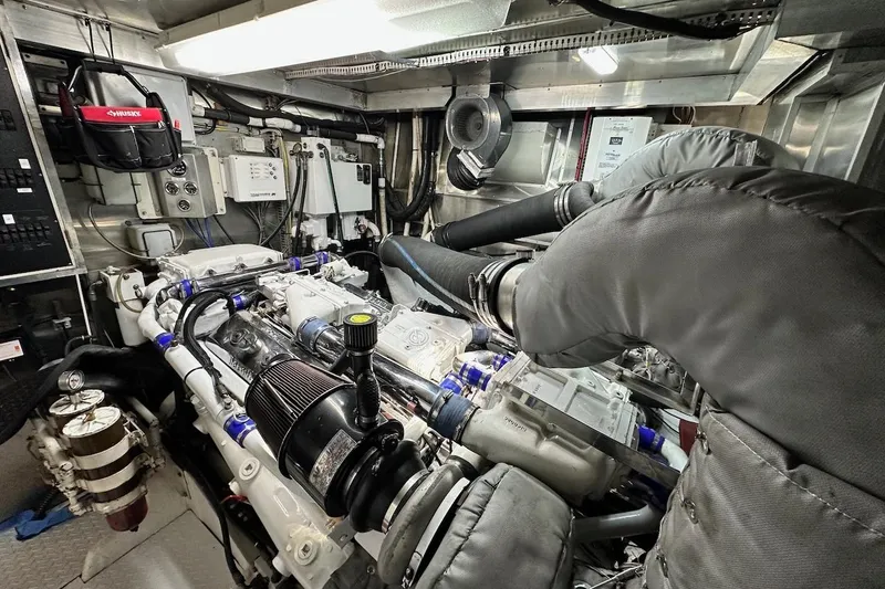 First Home Yacht Photos Pics Engine room of a 1988 Cheoy Lee 92 yacht, showcasing complex machinery and equipment.