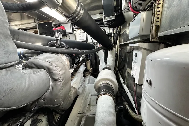 First Home Yacht Photos Pics Engine room of a 1988 Cheoy Lee 92 yacht, showcasing complex piping and machinery.