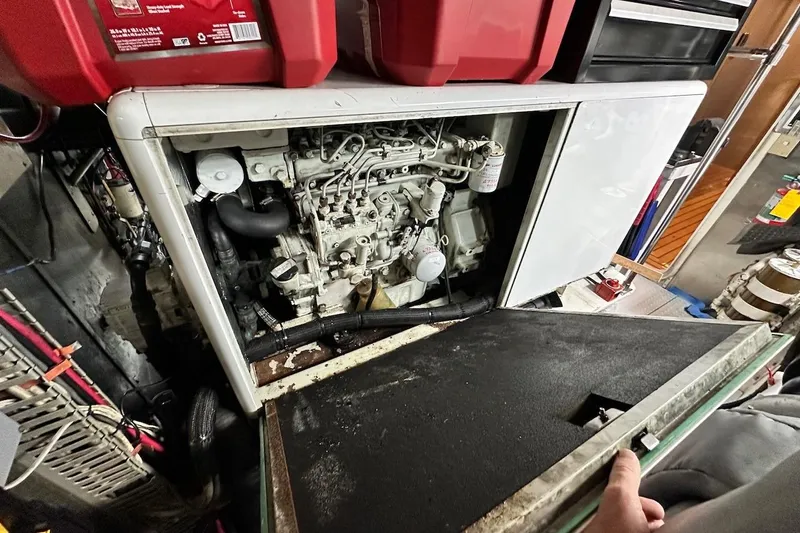 First Home Yacht Photos Pics Engine compartment of a 1988 Cheoy Lee 92 yacht, showcasing mechanical components.