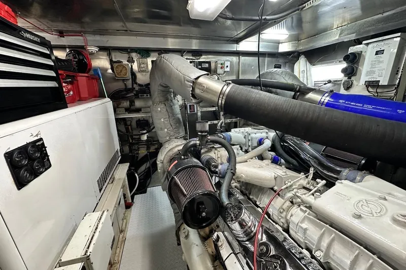 First Home Yacht Photos Pics Engine room of a 1988 Cheoy Lee 92 yacht, featuring complex machinery and equipment.