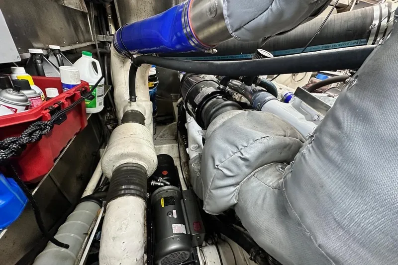 First Home Yacht Photos Pics Engine room of 1988 Cheoy Lee 92 yacht with various mechanical components and supplies.