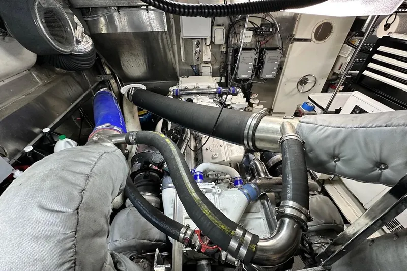 First Home Yacht Photos Pics Engine room of a 1988 Cheoy Lee 92 yacht, showcasing complex machinery and piping.