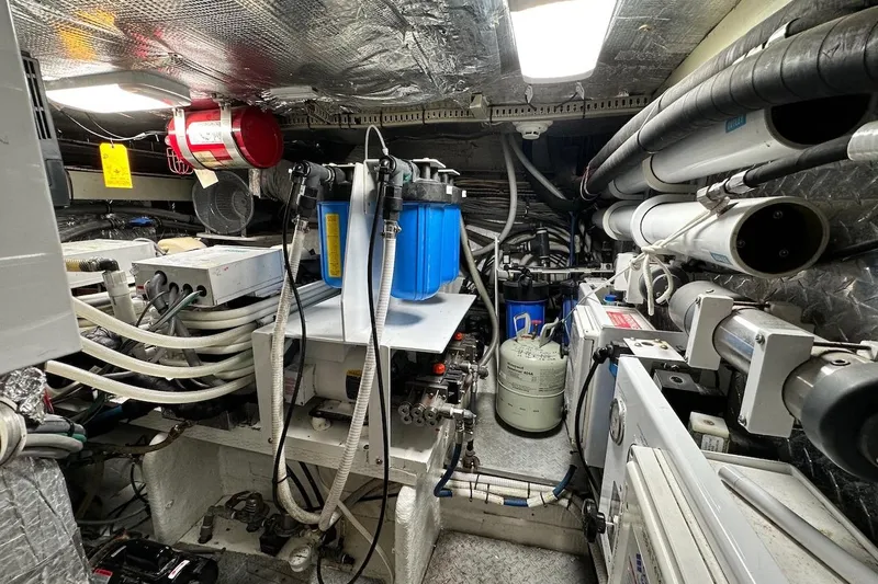 First Home Yacht Photos Pics Engine room of 1988 Cheoy Lee 92 yacht, featuring complex machinery and piping systems.