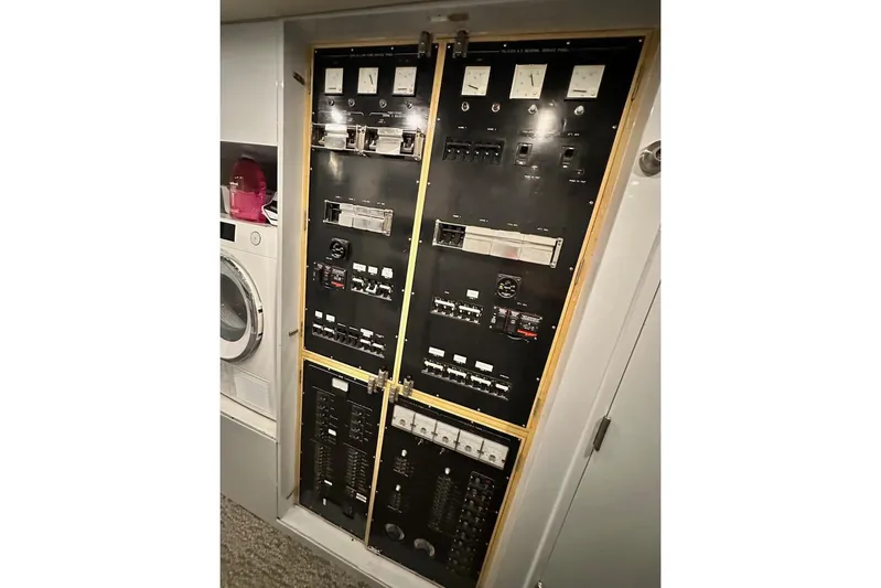First Home Yacht Photos Pics Electrical control panel on 1988 Cheoy Lee 92 yacht, adjacent to laundry appliances.