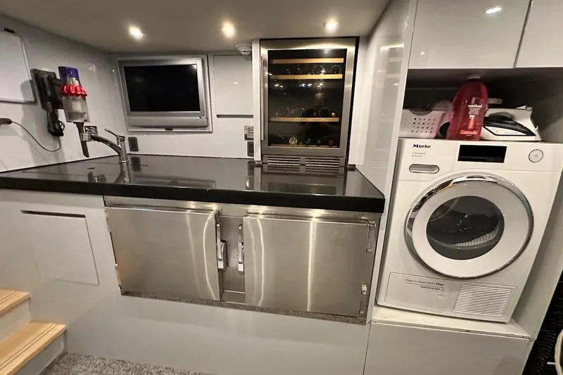 First Home Yacht Photos Pics Laundry area in 1988 Cheoy Lee 92 yacht with washer, dryer, and wine cooler.