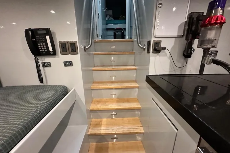 First Home Yacht Photos Pics Interior of 1988 Cheoy Lee 92 yacht with wooden stairs and modern amenities.