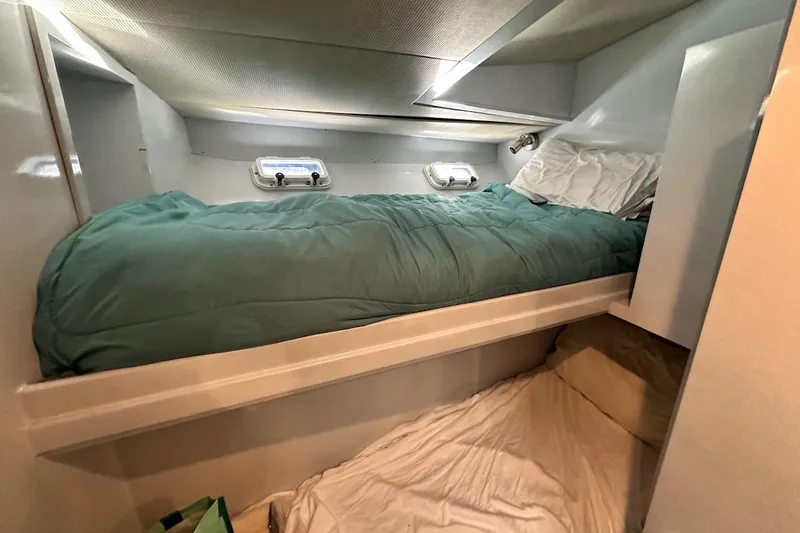 First Home Yacht Photos Pics Cozy cabin interior of 1988 Cheoy Lee 92 yacht with bunk beds and portholes.