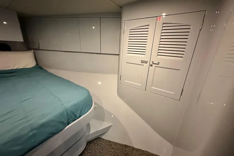 First Home Yacht Photos Pics Interior cabin of 1988 Cheoy Lee 92 yacht with bed and storage cabinets.