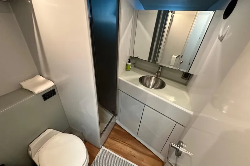 First Home Yacht Photos Pics Bathroom interior of 1988 Cheoy Lee 92 yacht with modern fixtures and sleek design.