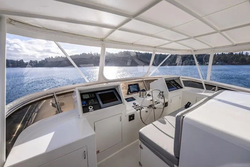 First Home Yacht Photos Pics Helm of 1988 Cheoy Lee 92 yacht with panoramic water view.