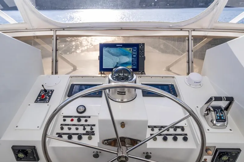 First Home Yacht Photos Pics Helm of 1988 Cheoy Lee 92 yacht with navigation equipment and steering wheel.