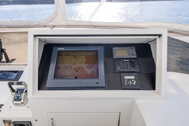 First Home Yacht Photos Pics Navigation equipment on 1988 Cheoy Lee 92 yacht, featuring Furuno display and controls.