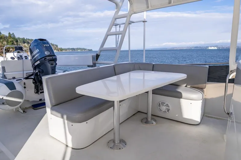 First Home Yacht Photos Pics Outdoor seating area on 1988 Cheoy Lee 92 yacht with ocean view.