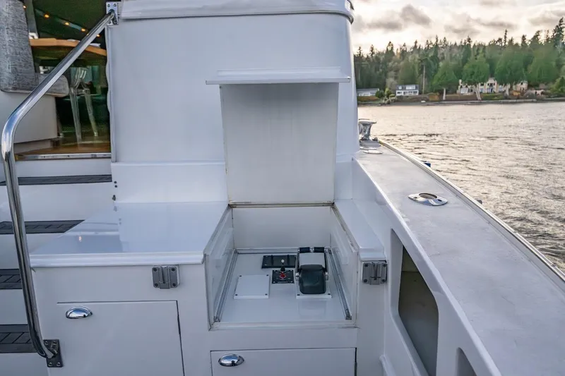 First Home Yacht Photos Pics 1988 Cheoy Lee 92 yacht deck with control panel, overlooking serene waterfront.