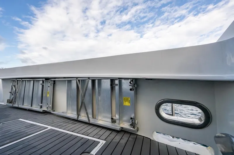 First Home Yacht Photos Pics Deck view of 1988 Cheoy Lee 92 yacht with metal fixtures and ocean backdrop.
