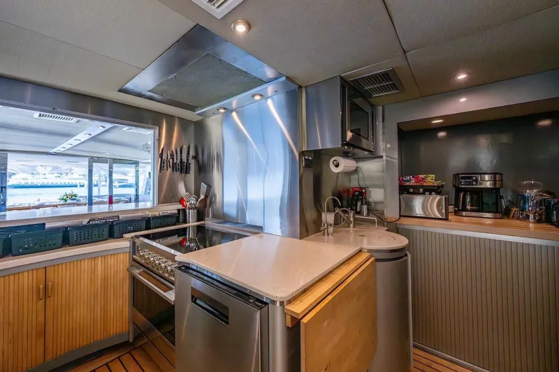 First Home Yacht Photos Pics Luxurious kitchen interior on 1988 Cheoy Lee 92 yacht, featuring modern appliances and sleek design.