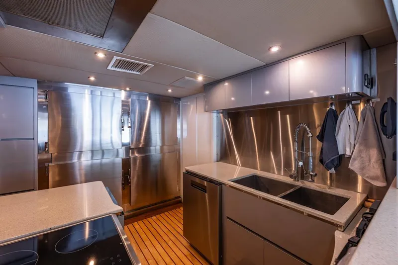 First Home Yacht Photos Pics Modern kitchen interior on 1988 Cheoy Lee 92 yacht with stainless steel appliances.