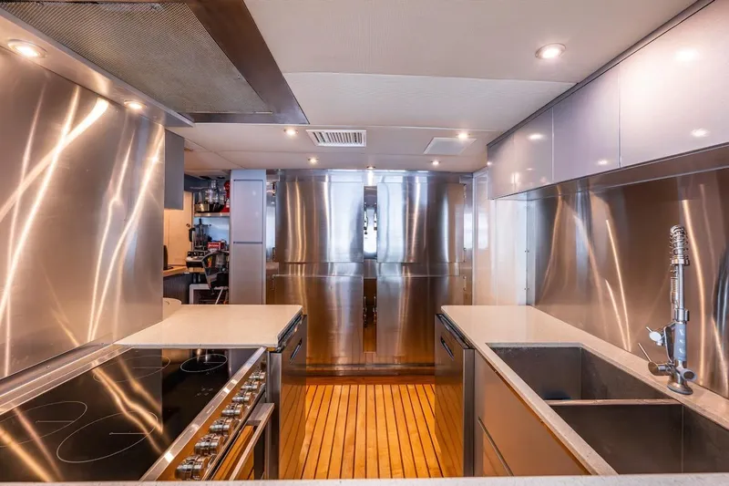 First Home Yacht Photos Pics Luxurious stainless steel kitchen interior on 1988 Cheoy Lee 92 yacht.