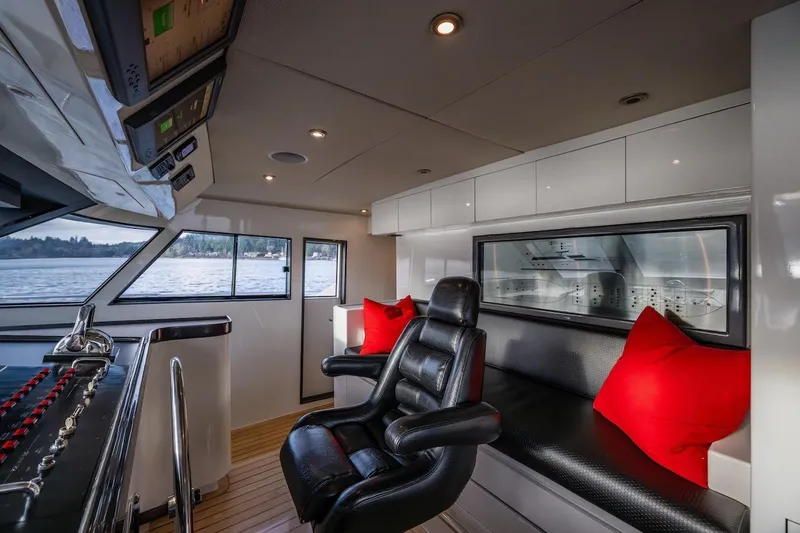 First Home Yacht Photos Pics Luxurious 1988 Cheoy Lee 92 yacht interior with leather seating and red cushions.