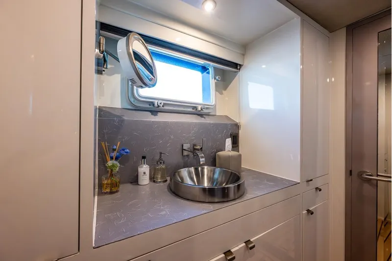 First Home Yacht Photos Pics Luxurious bathroom interior of 1988 Cheoy Lee 92 yacht with modern sink and window.