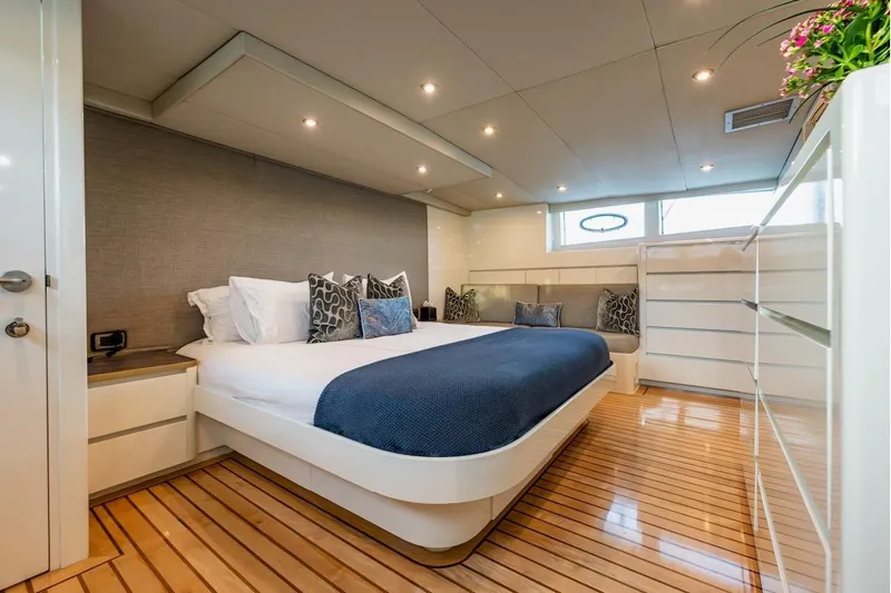 First Home Yacht Photos Pics Luxurious bedroom interior on 1988 Cheoy Lee 92 yacht with modern decor and wooden flooring.
