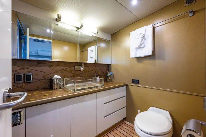 First Home Yacht Photos Pics Luxurious bathroom in 1988 Cheoy Lee 92 yacht with modern fixtures and elegant design.
