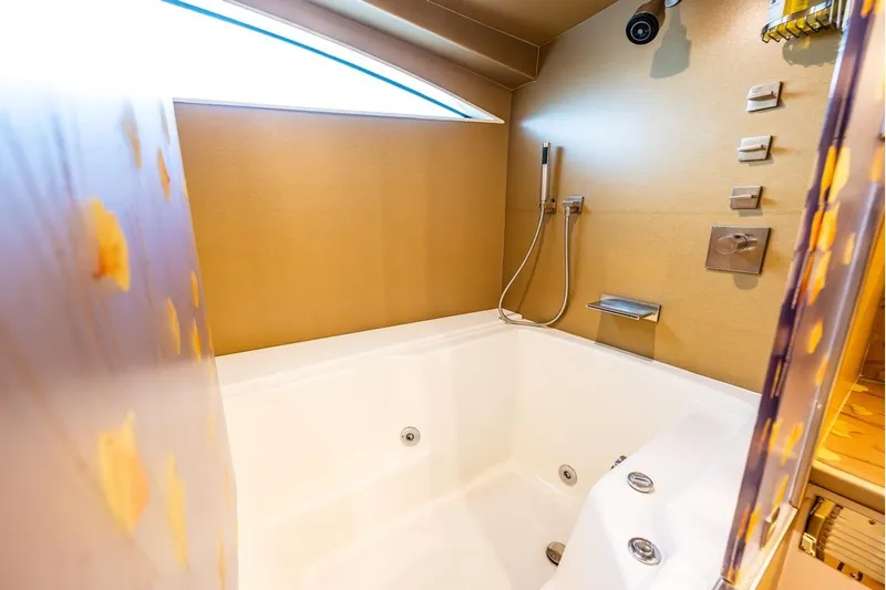 First Home Yacht Photos Pics Luxurious bathtub in 1988 Cheoy Lee 92 yacht, featuring modern fixtures and elegant design.