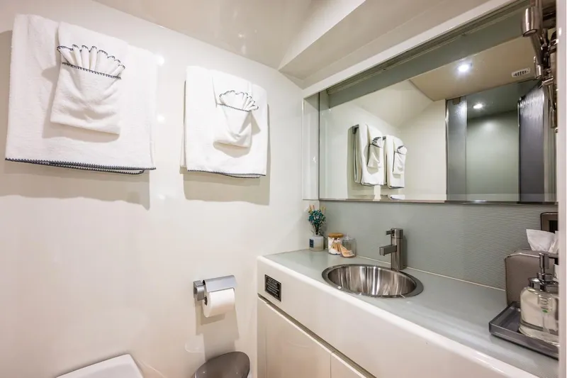 First Home Yacht Photos Pics Luxurious bathroom in 1988 Cheoy Lee 92 yacht with modern sink and elegant towels.