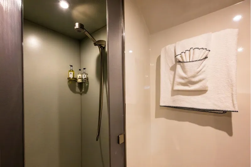 First Home Yacht Photos Pics Luxurious shower area on 1988 Cheoy Lee 92 yacht with elegant towel display.