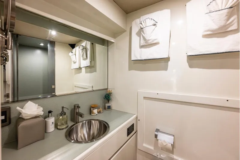 First Home Yacht Photos Pics Luxurious bathroom in 1988 Cheoy Lee 92 yacht with modern fixtures and elegant decor.