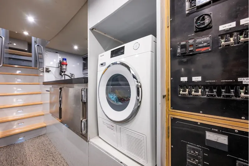 First Home Yacht Photos Pics Laundry area and control panel inside a 1988 Cheoy Lee 92 yacht.